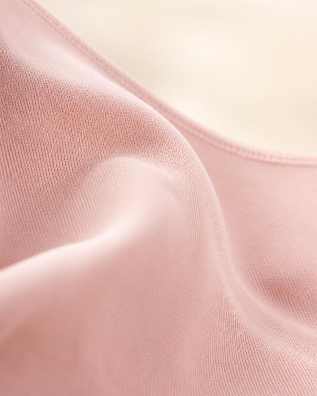 Macro texture shot of soft blush double-knit modal fabric used in VELRA's Aura bralette